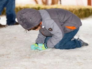 A child playing in snow at Snow Day in Bastrop TX