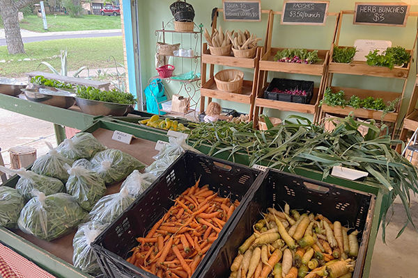 Eden East Farm Stand with vegetables and herbs displayed in Bastrop, Texas